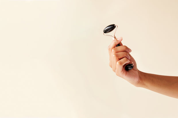 massage device in a hand on yellow background